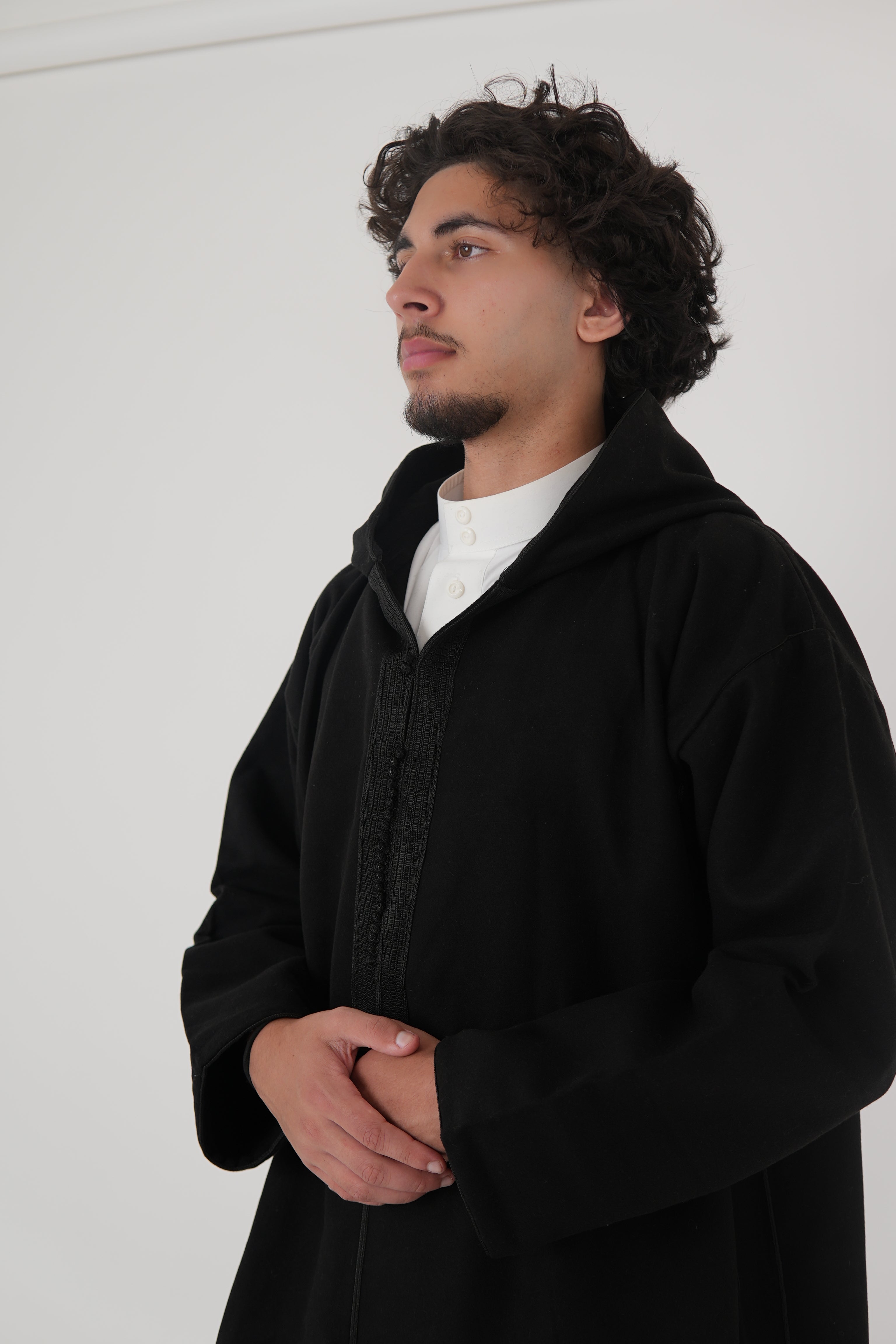 Man wearing a Black Moroccan Djellaba – traditional hooded thobe robe