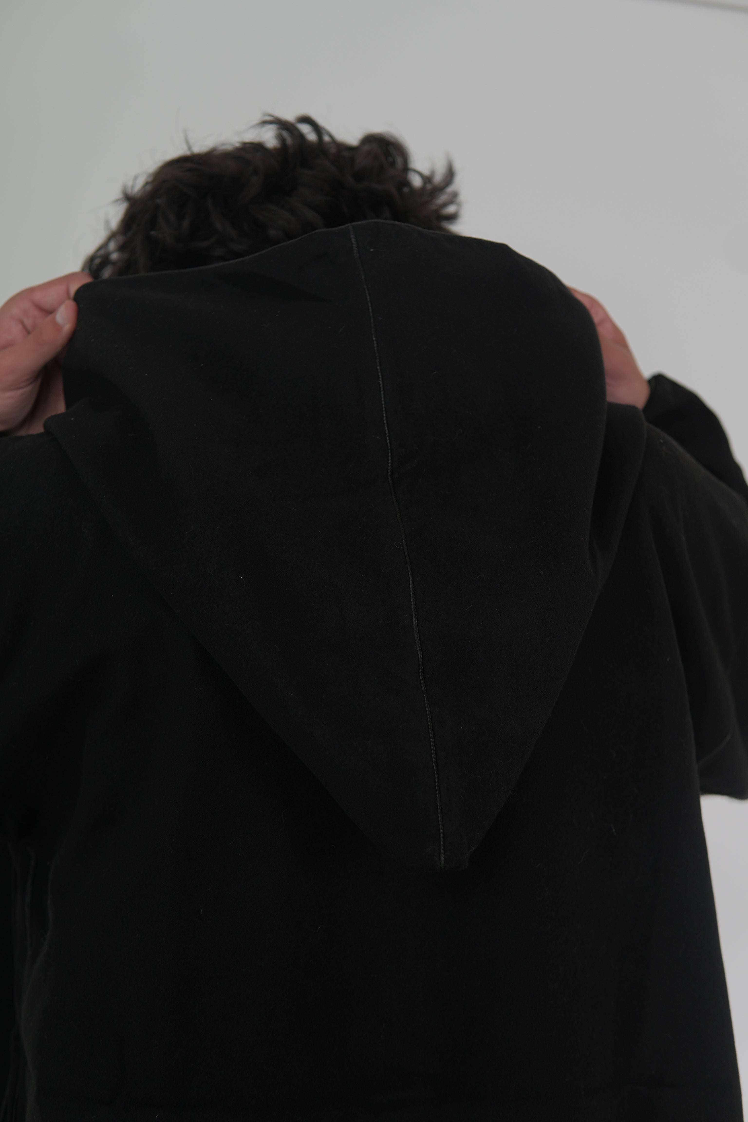 Man wearing a Black Moroccan Djellaba – traditional hooded thobe robe